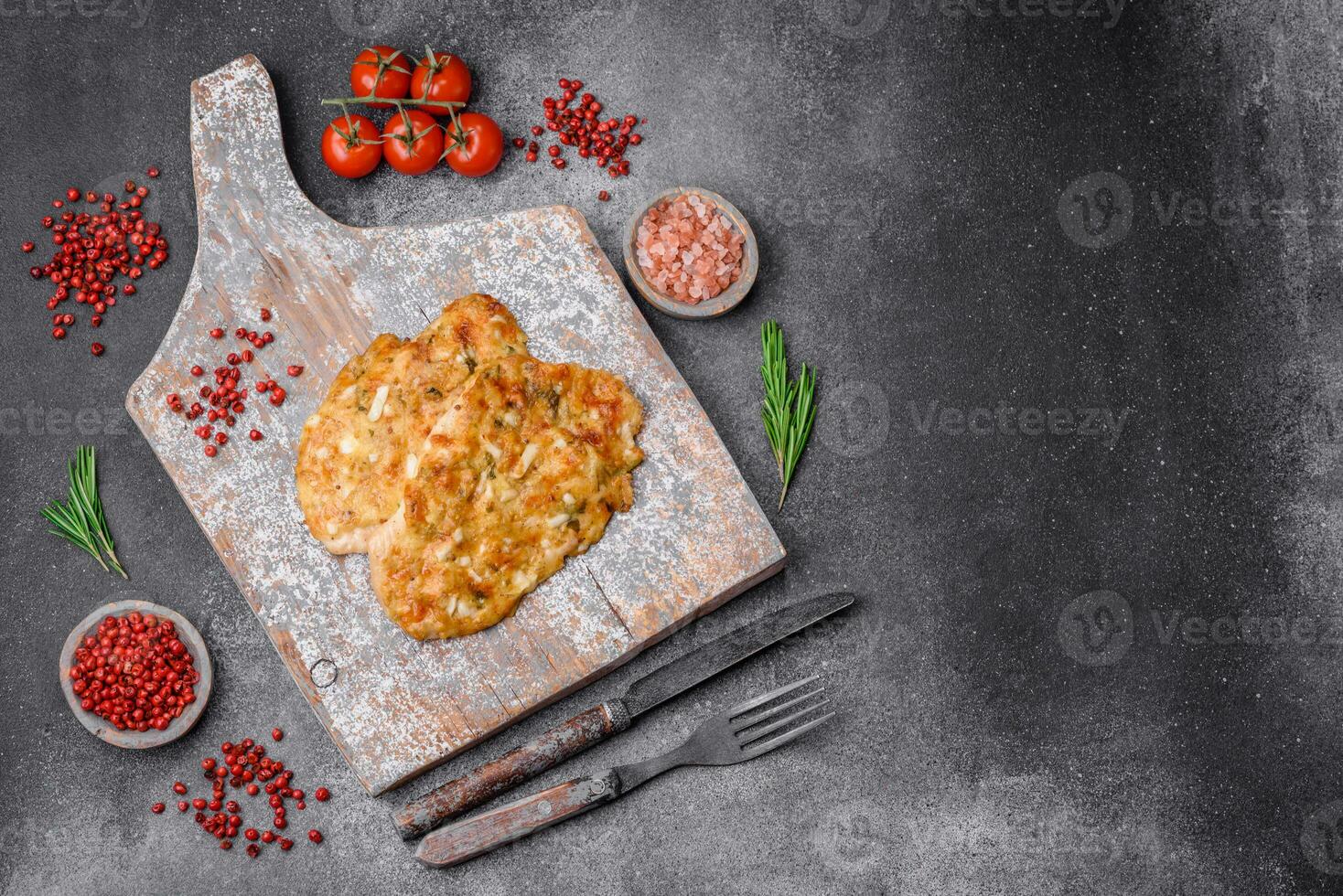 Delicious fried chicken breast in batter with mustard, salt, spices and cheese photo