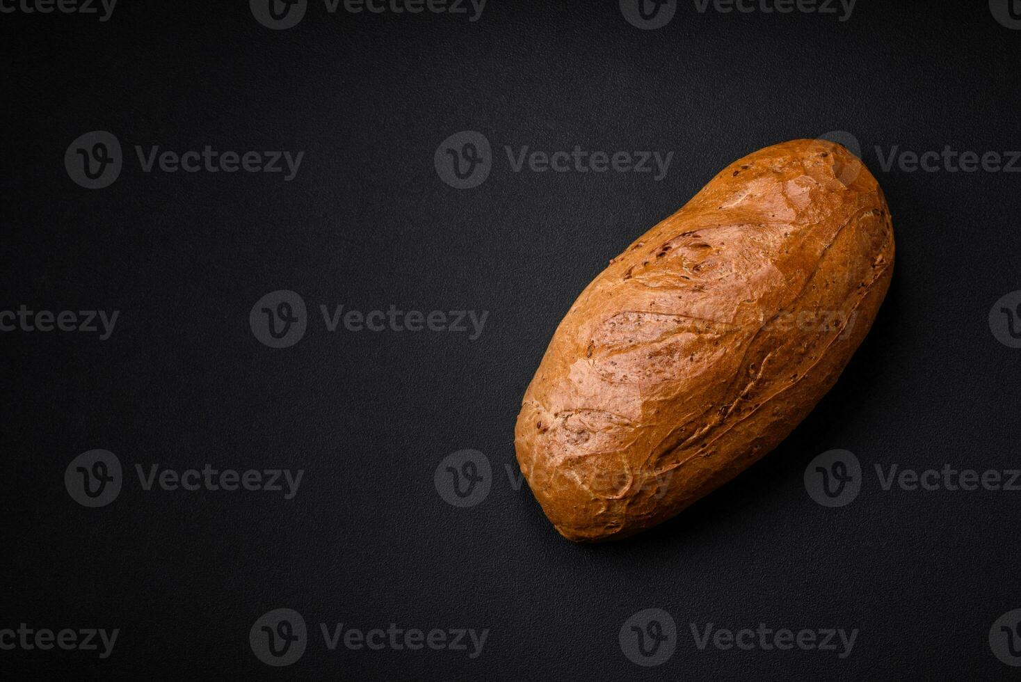 Delicious fresh crispy loaf of white bread with grains and seeds photo