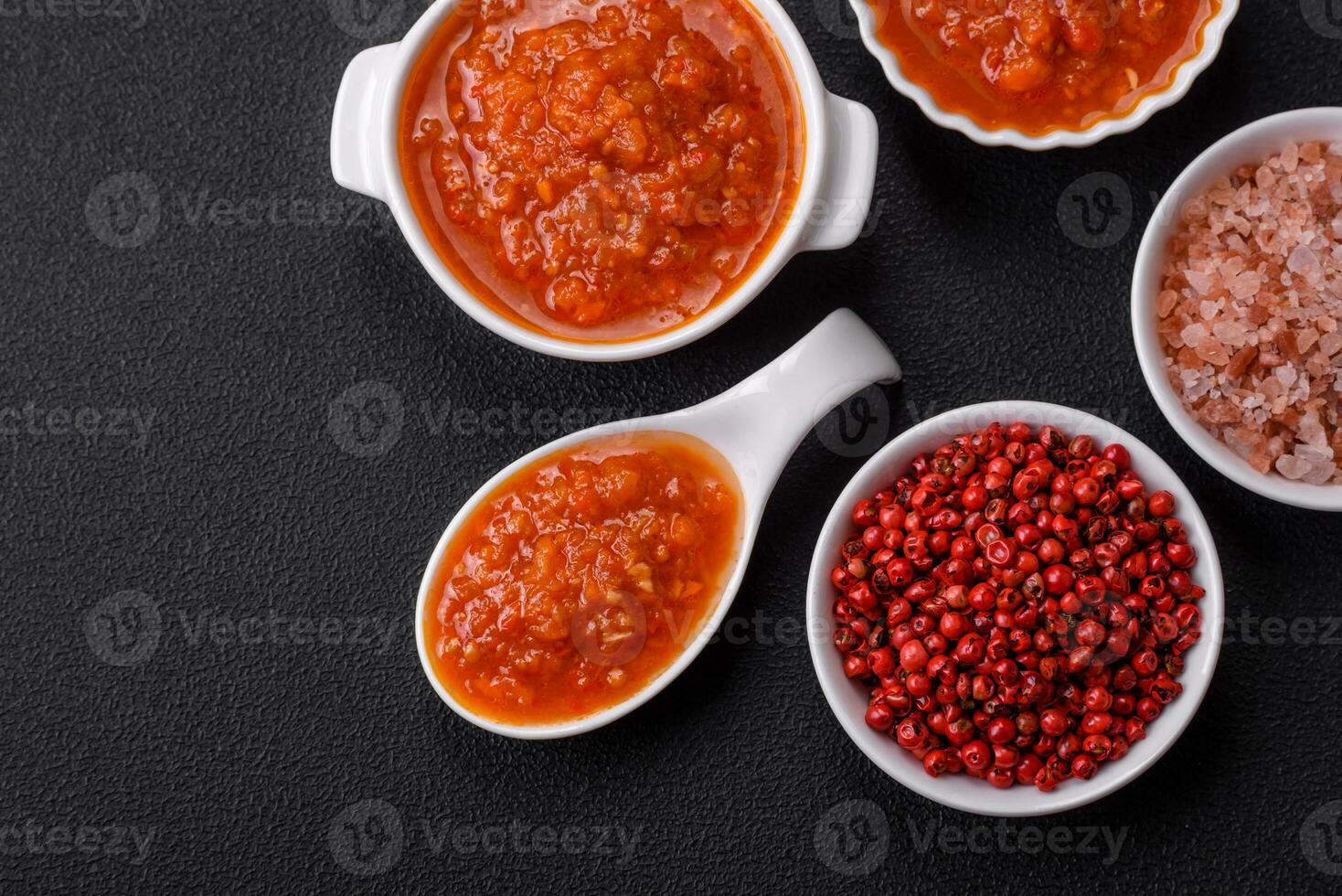 Delicious spicy tomato sauce with pepper, garlic, salt, spices and herbs photo