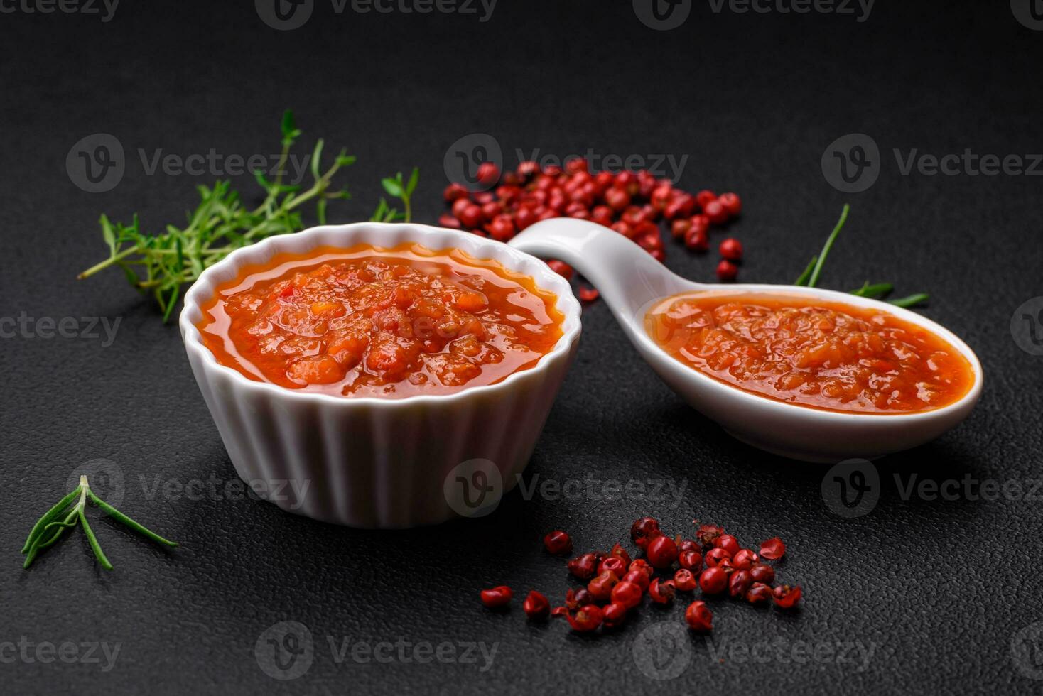 Delicious spicy tomato sauce with pepper, garlic, salt, spices and herbs photo