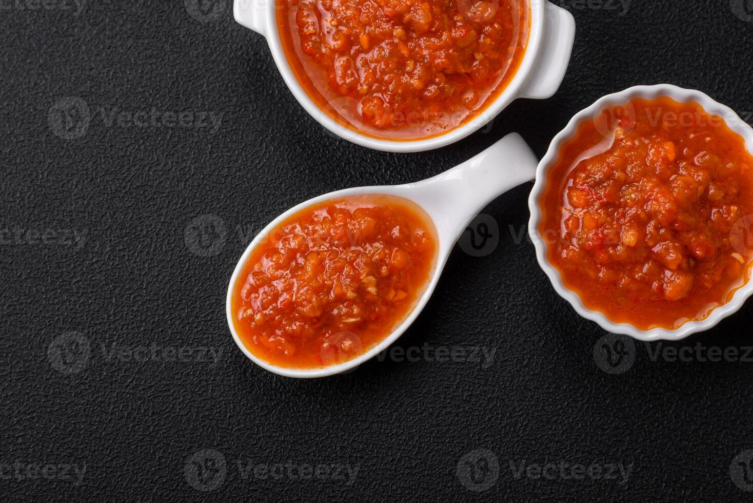 Delicious spicy tomato sauce with pepper, garlic, salt, spices and herbs photo