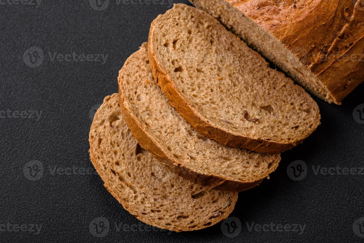 Delicious fresh crispy loaf of white bread with grains and seeds photo