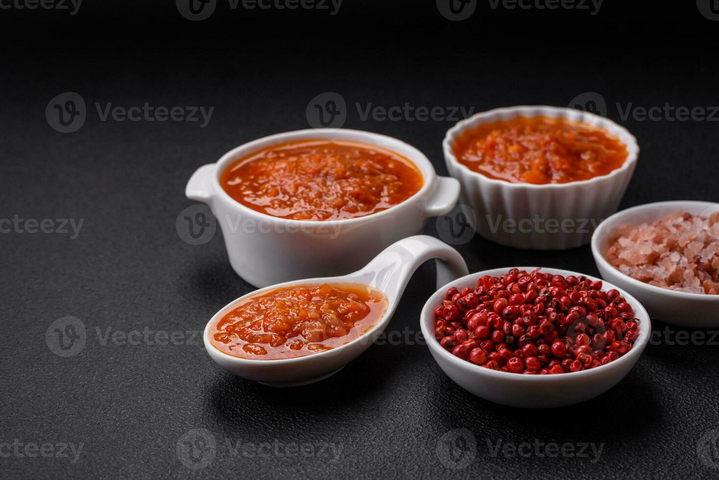 Delicious spicy tomato sauce with pepper, garlic, salt, spices and herbs photo