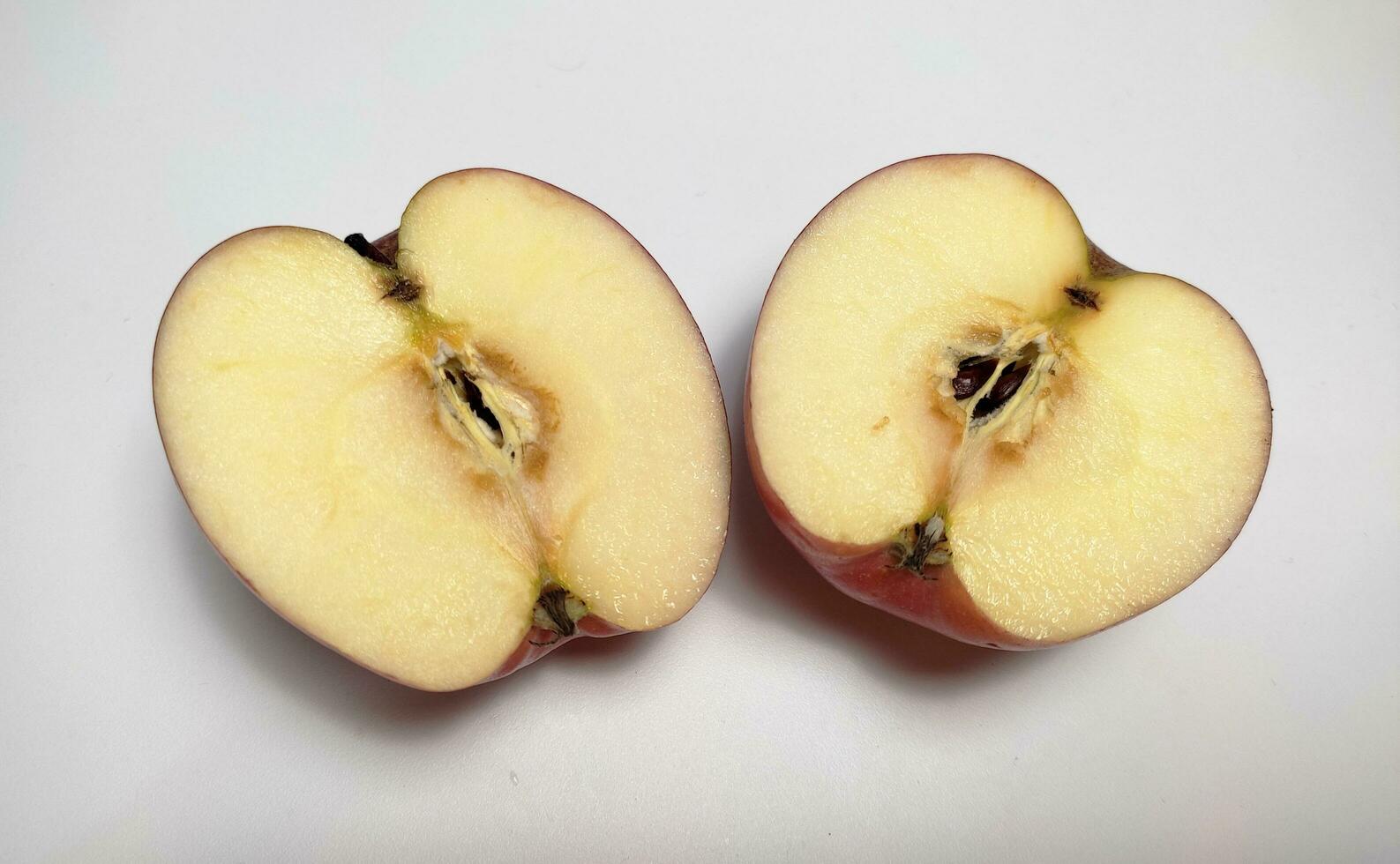 Red apple, halved, on a white background photo