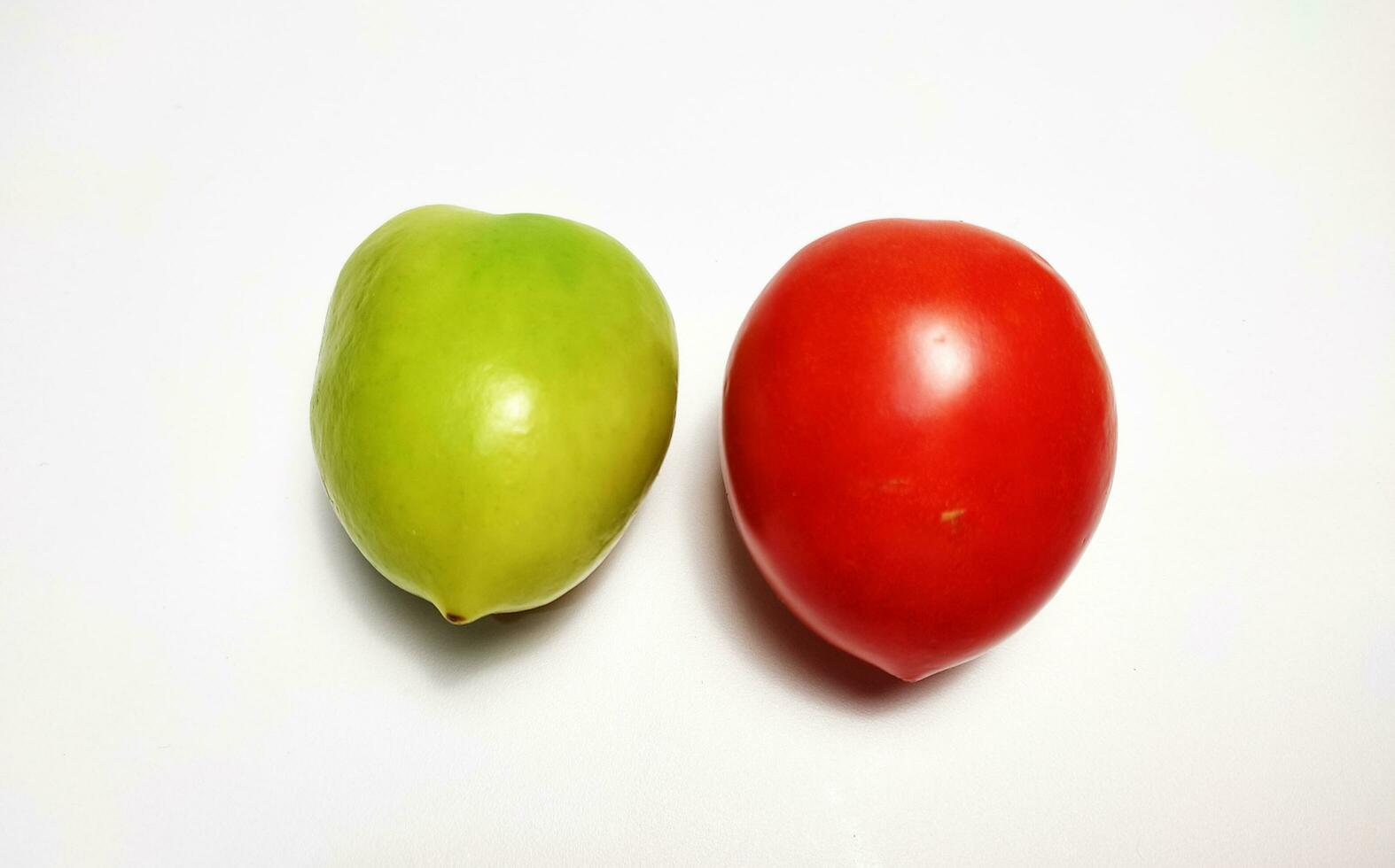 Red tomato and green tomato, isolated on white background. photo