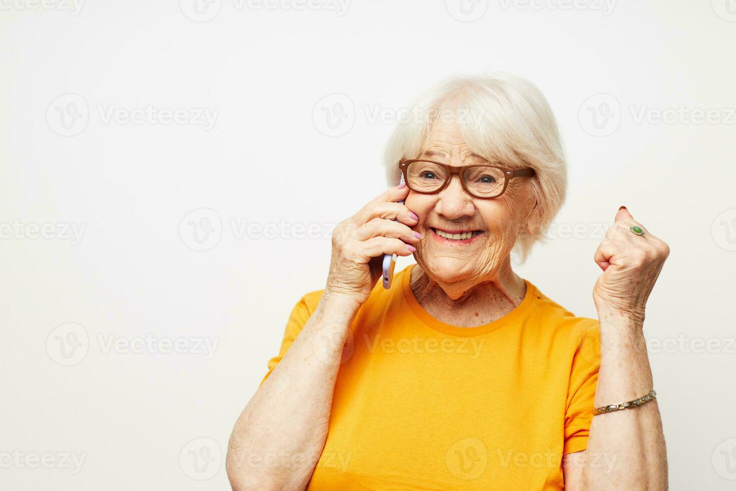 Portrait of an old friendly woman happy lifestyle in yellow t-shirts close-up emotions photo