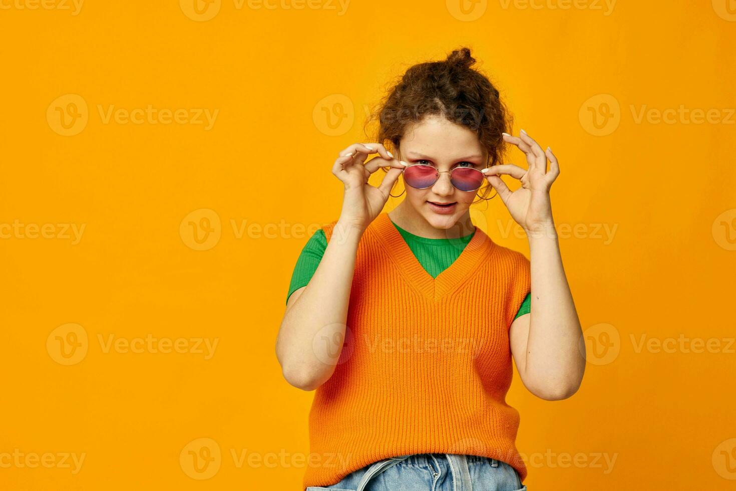 portrait of a young woman multicolored sunglasses on face posing grimace isolated backgrounds unaltered photo