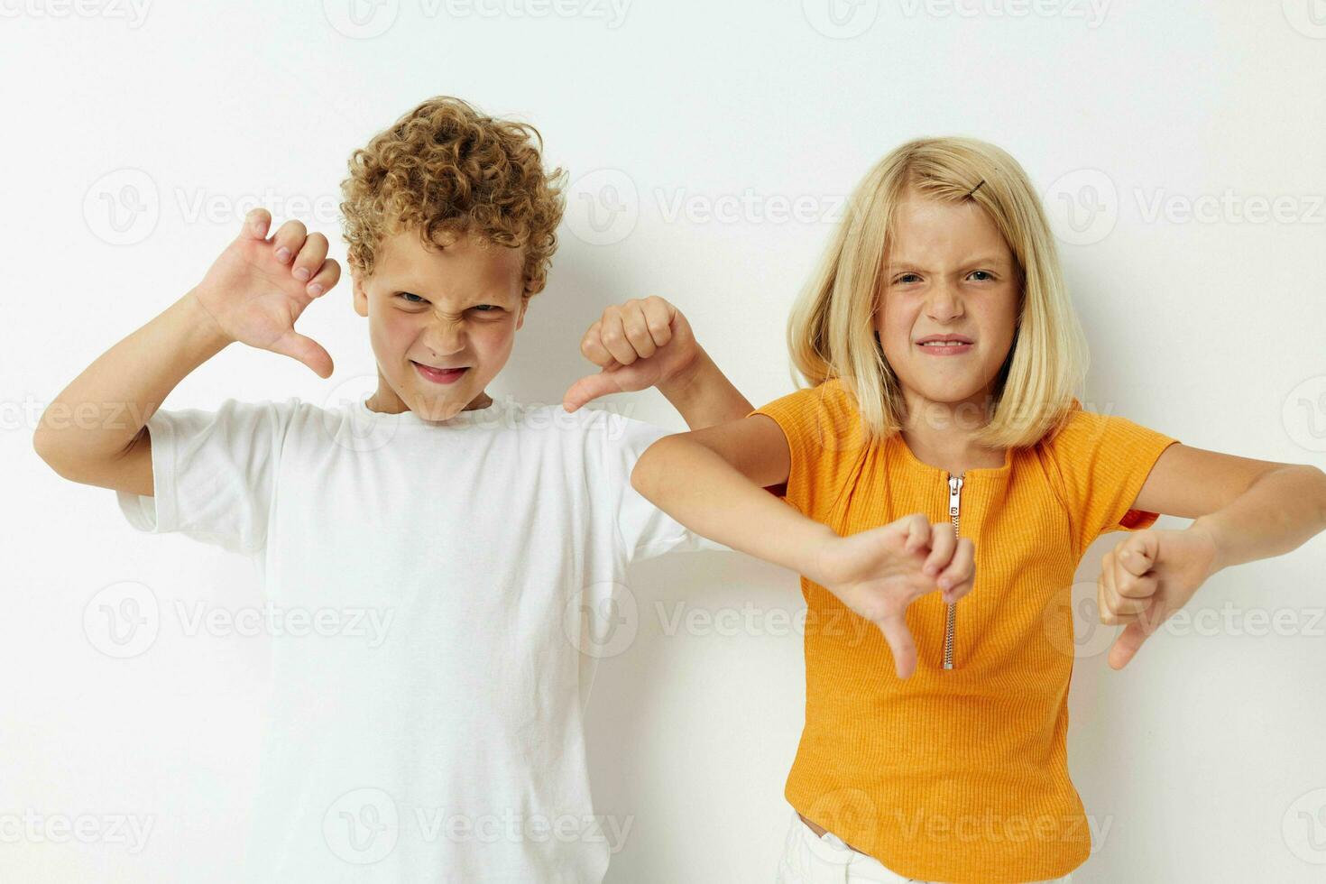 two joyful children casual clothes posing emotions studio isolated background unaltered photo