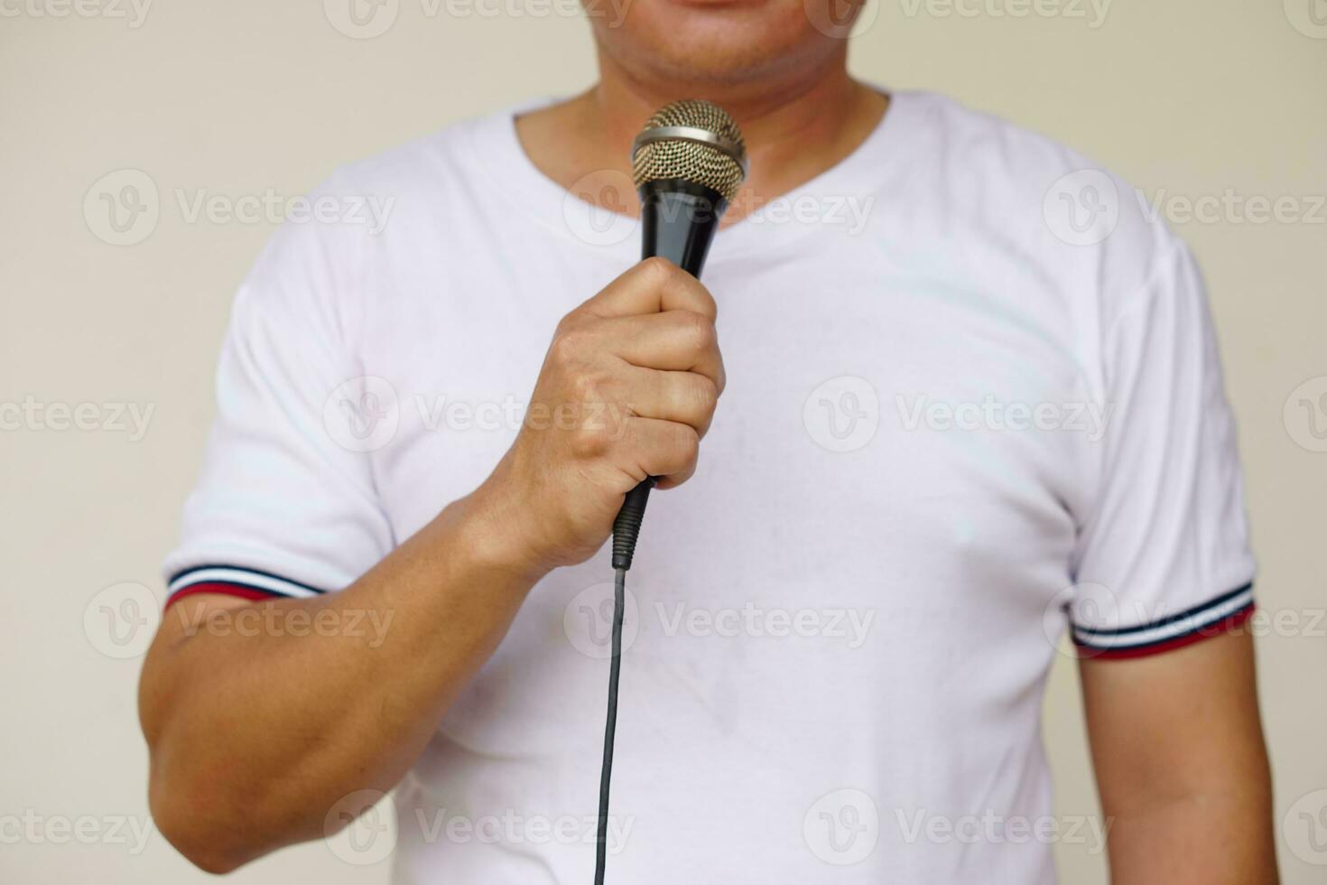 Man holds and speak or sing on microphone. Concept, tool or device technology that translates sound vibrations in the air into electronic signals to  loudspeaker for entertainment or public speaking. photo