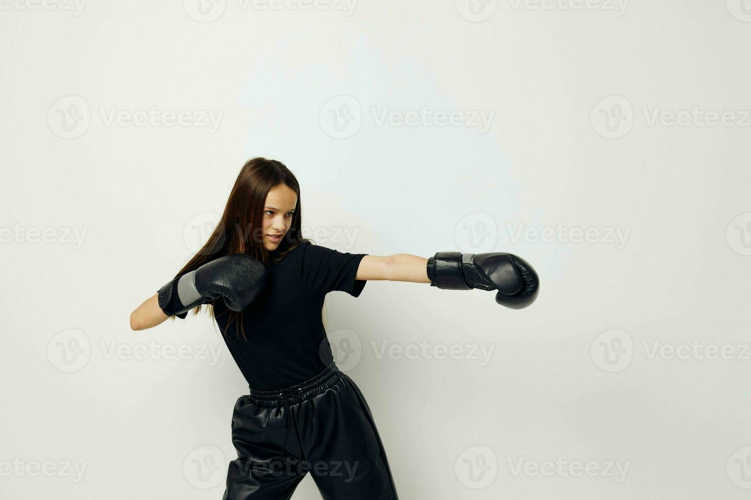 beautiful girl in black sports uniform boxing gloves posing fitness training photo