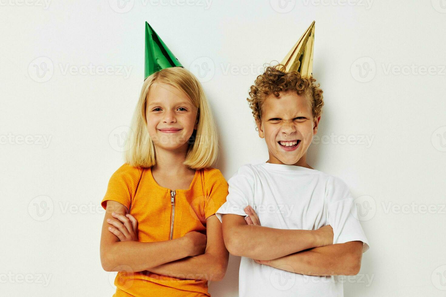 Portrait of cute children with caps on his head holiday entertainment light background photo