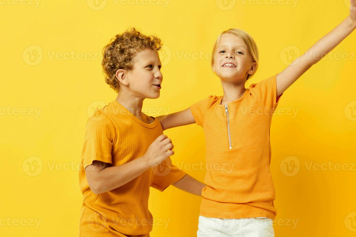 Cute preschool kids cuddling fashion childhood entertainment yellow background unaltered photo