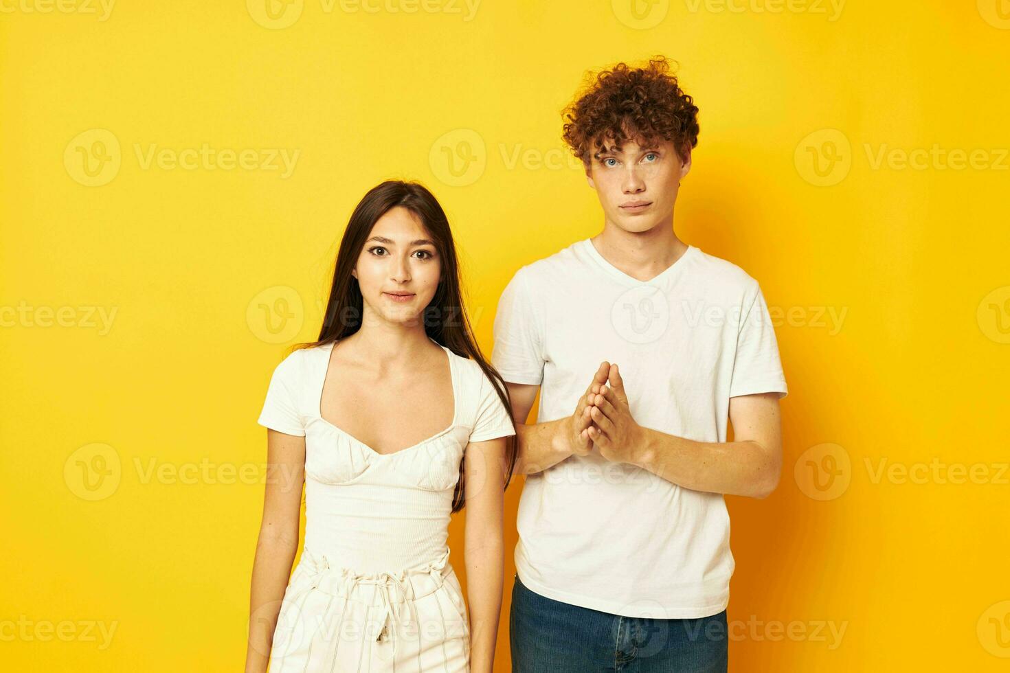 cute young couple posing together in white t-shirts friendship isolated background unaltered photo