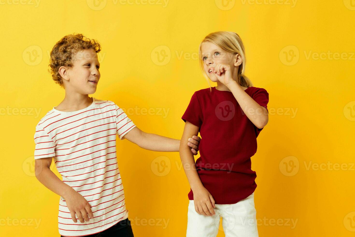 picture of positive boy and girl casual wear games fun together on colored background photo