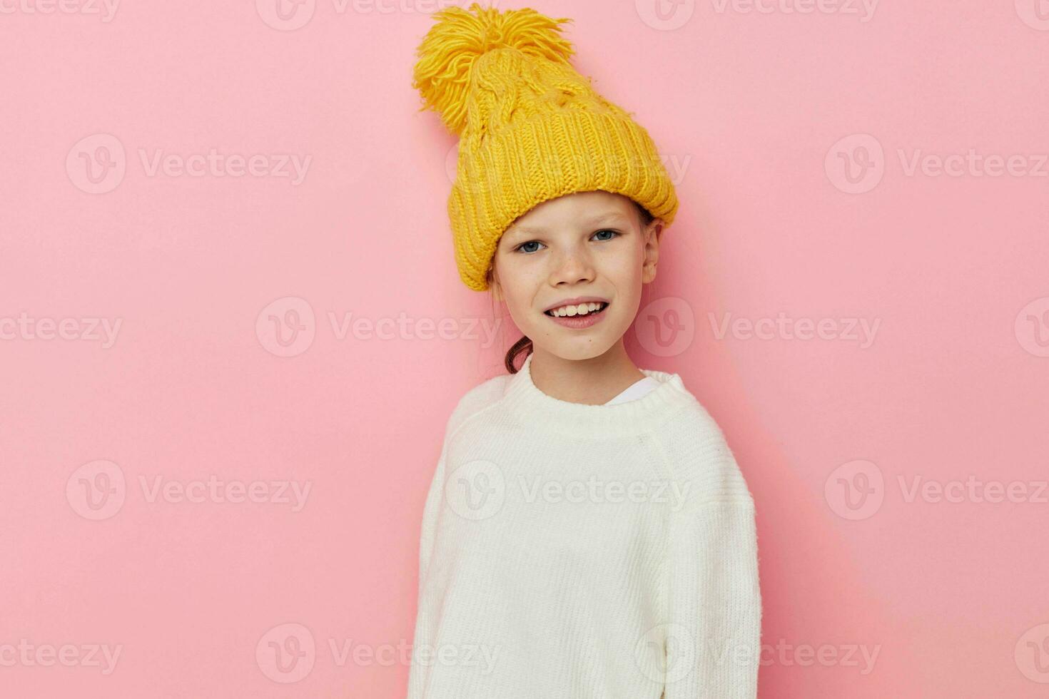 Portrait of happy smiling child girl fun in a yellow hat fun childhood unaltered photo