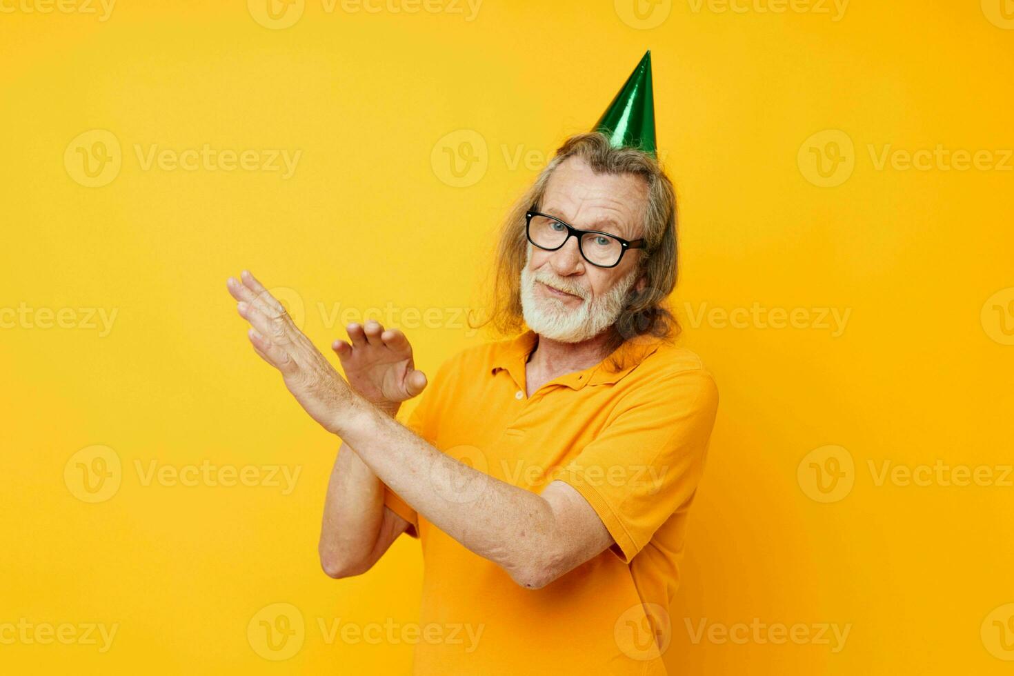 Photo of retired old man in a yellow t-shirt with a cap on his head fun cropped view