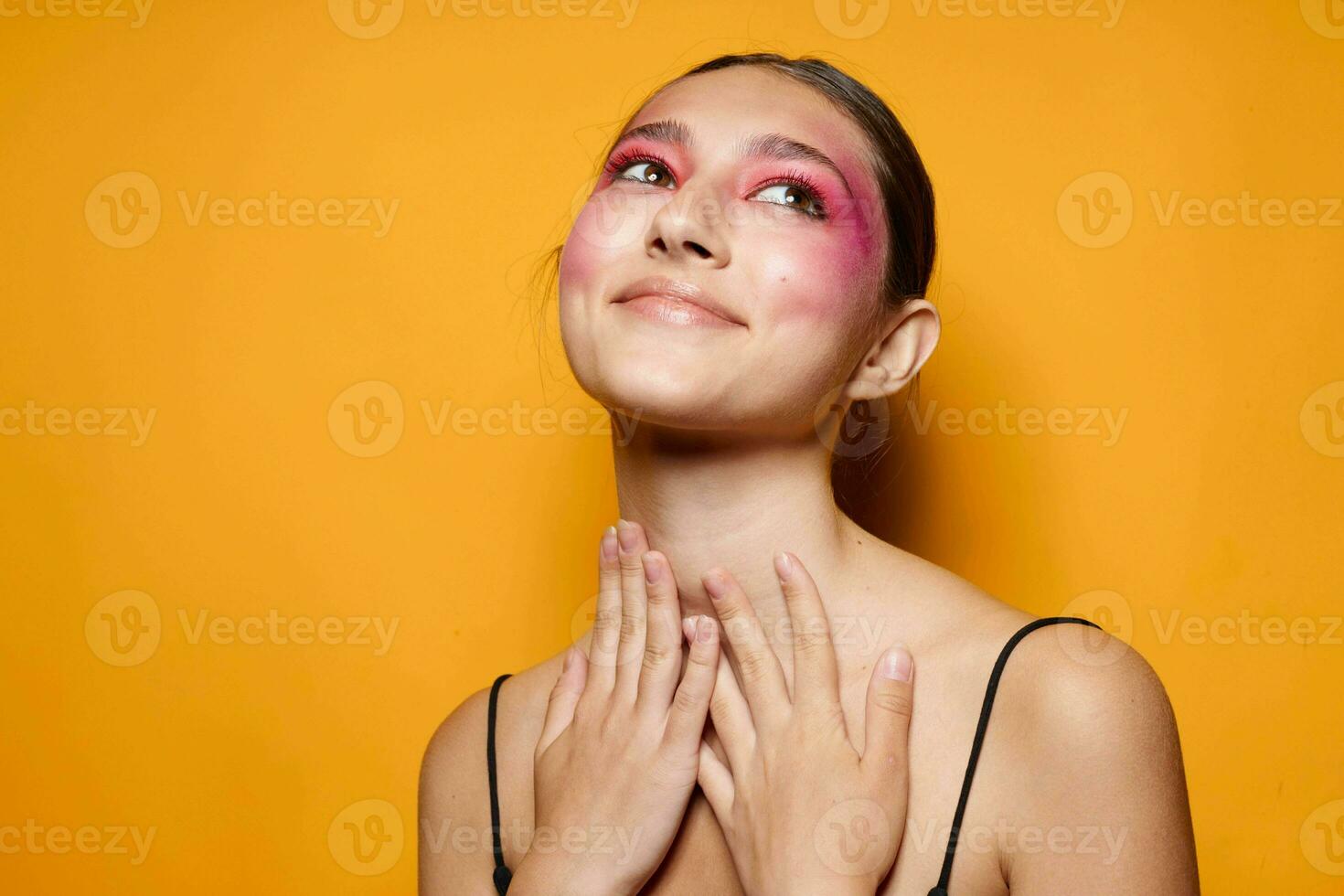 Sexy brunette woman bright makeup posing fashion emotions yellow background unaltered photo