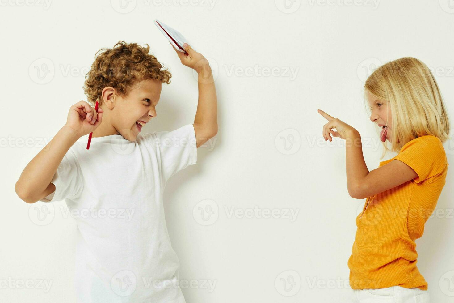 Cheerful boy and girl stand side by side posing light background photo