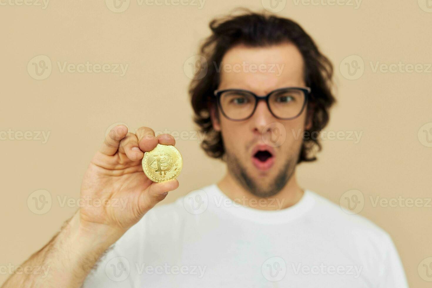 handsome man in a white T-shirt with Bitcoin cryptocurrency Lifestyle unaltered photo