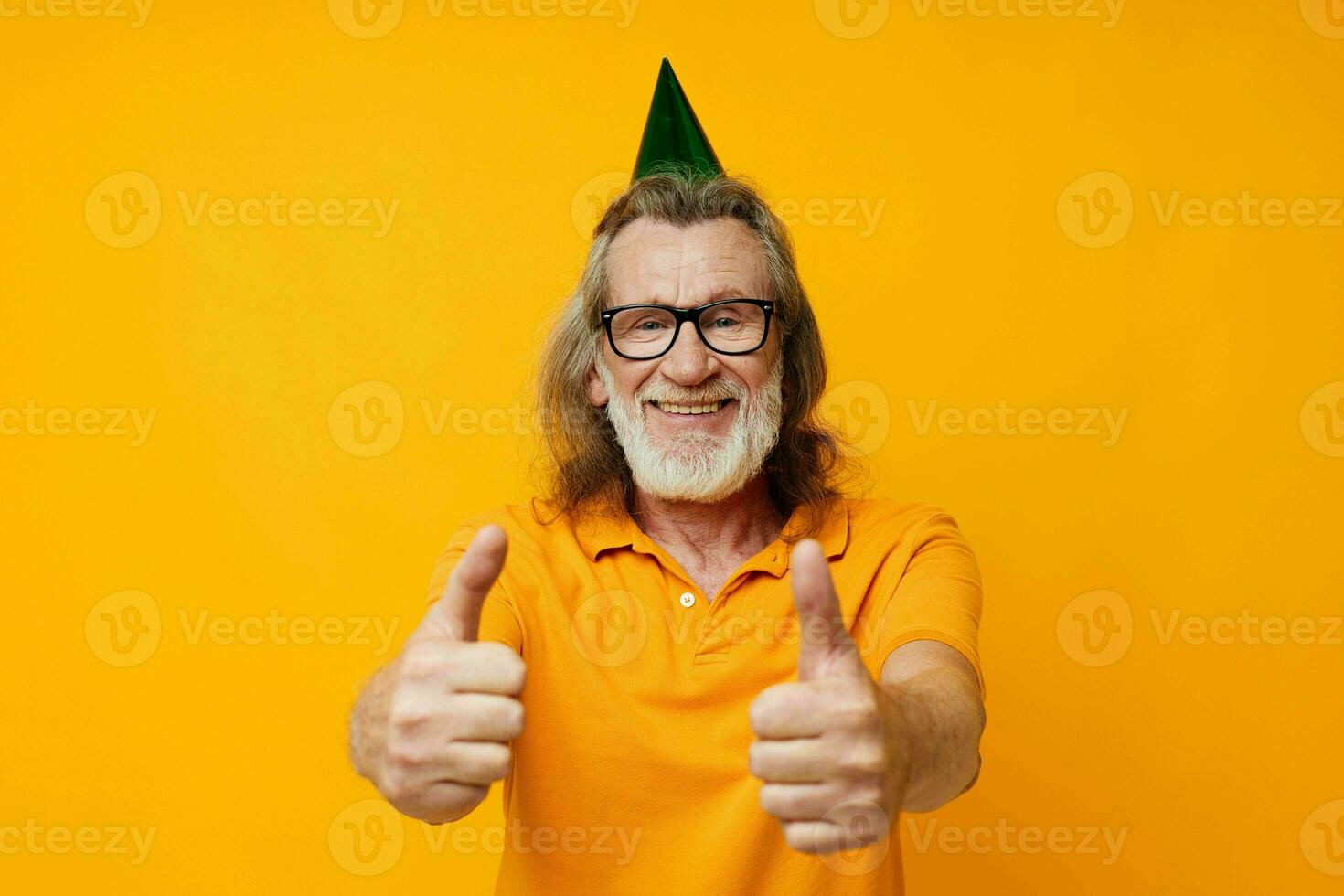 Senior grey-haired man wearing glasses green cap on his head holiday emotions monochrome shot photo