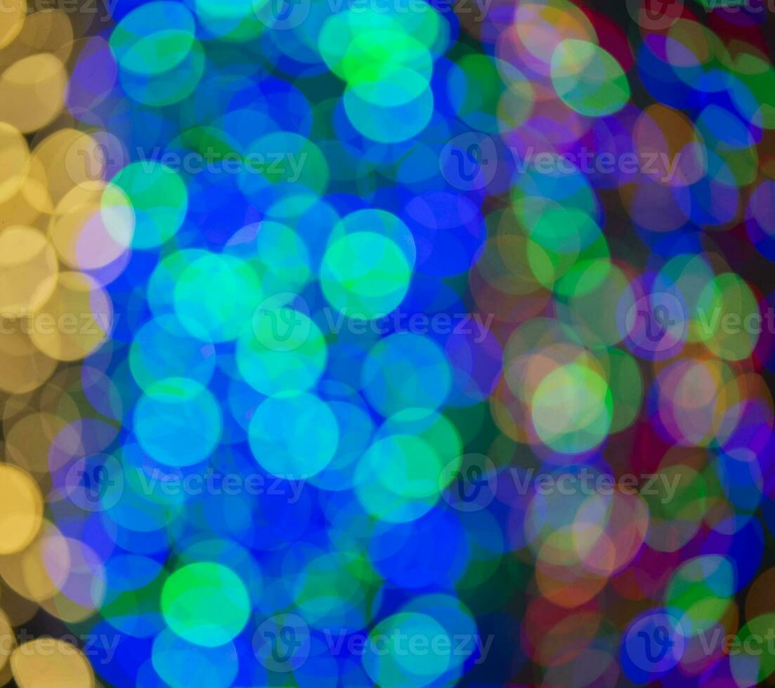 Multi-colored large bokeh spots of blue, yellow and orange. Bokeh from a Christmas garland. photo