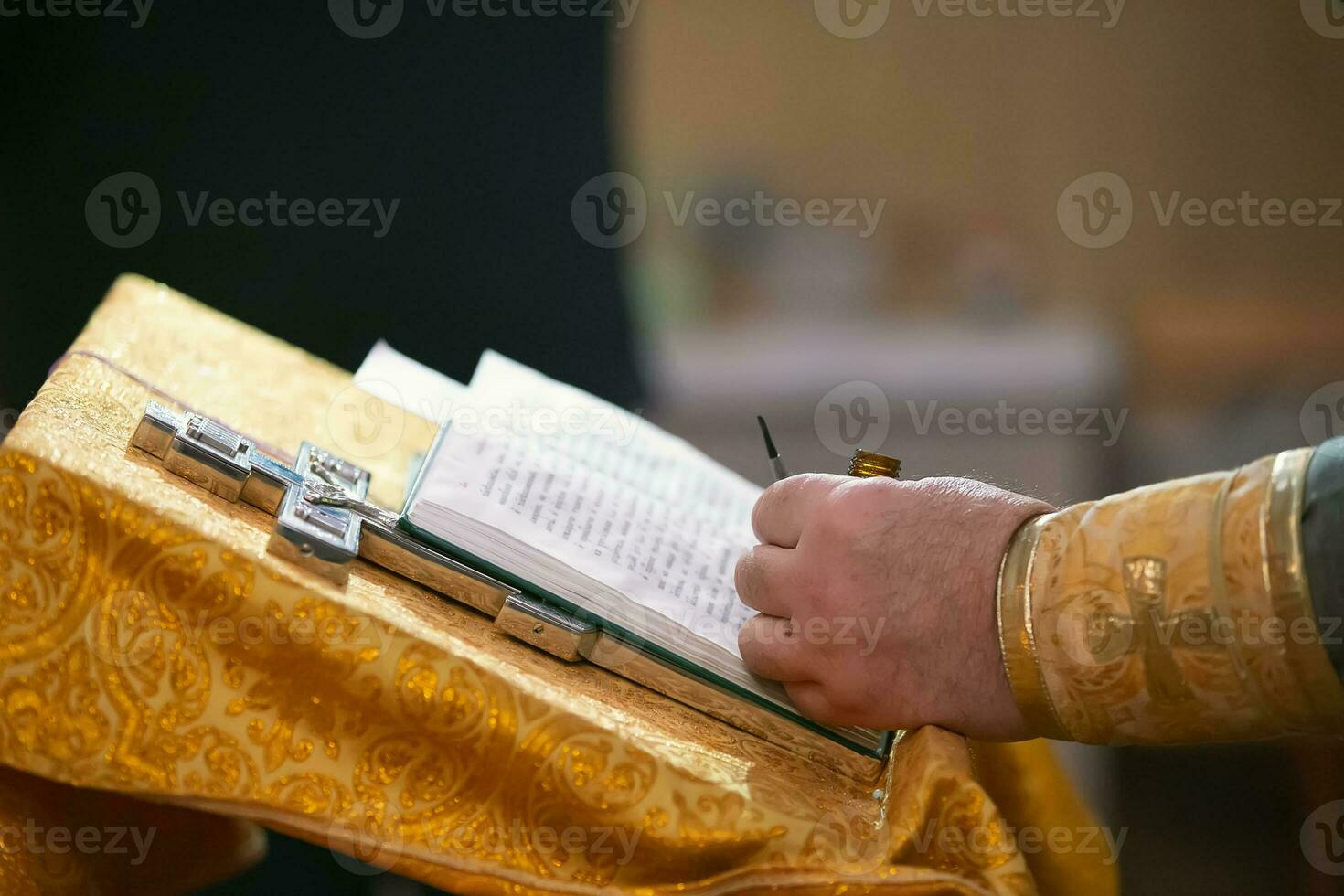 Religious background. Priest hands cross and bible. photo