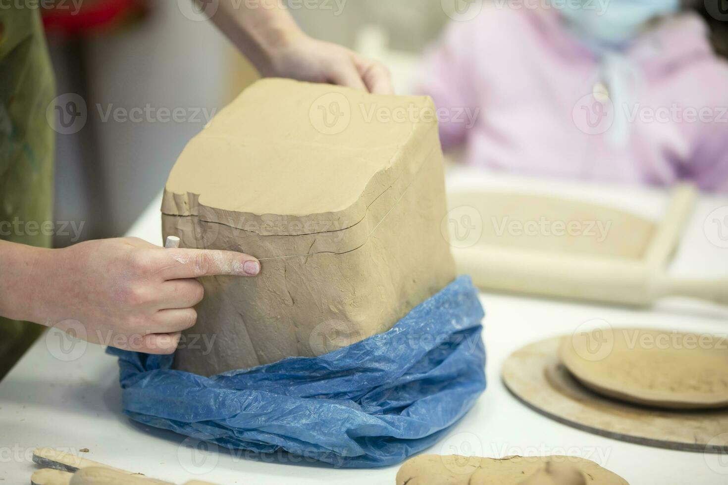 A piece of clay is cut off on the table. photo