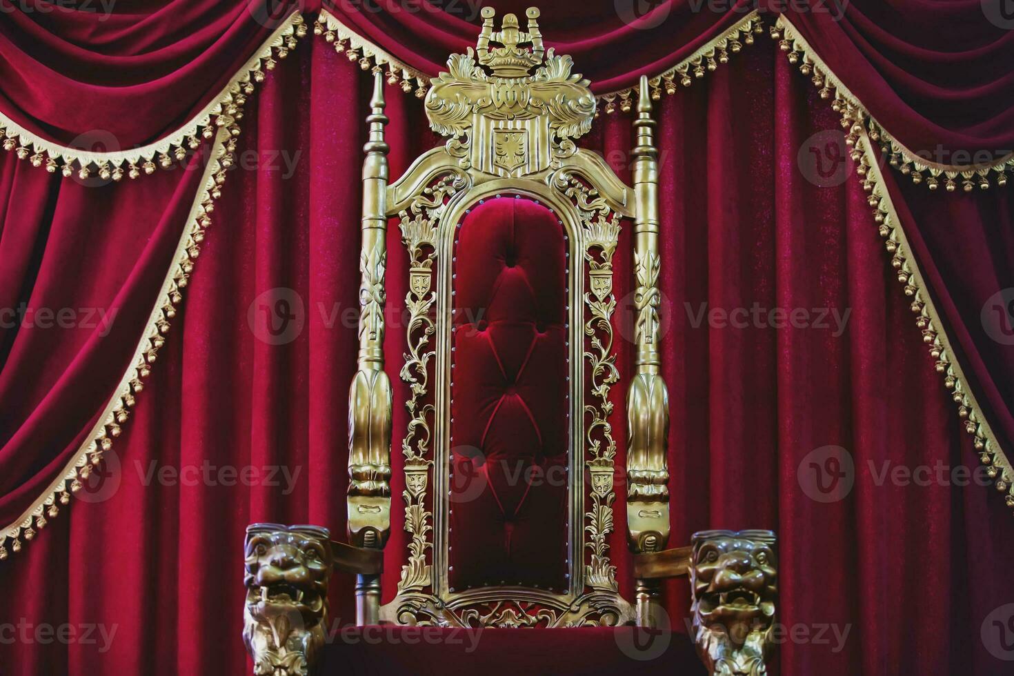 Part of the red royal chair against the background of red curtains. A place for a king. Throne photo