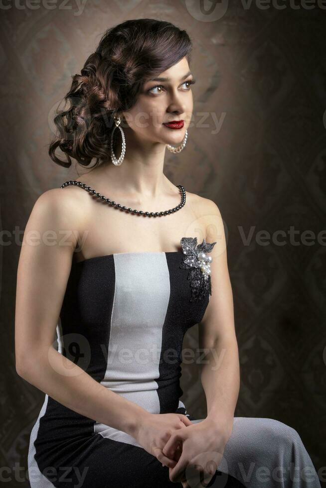 Retro woman portrait. Beautiful lady in 20s or 30s style. Old fashionable Finger Wave makeup and hairstyle. photo