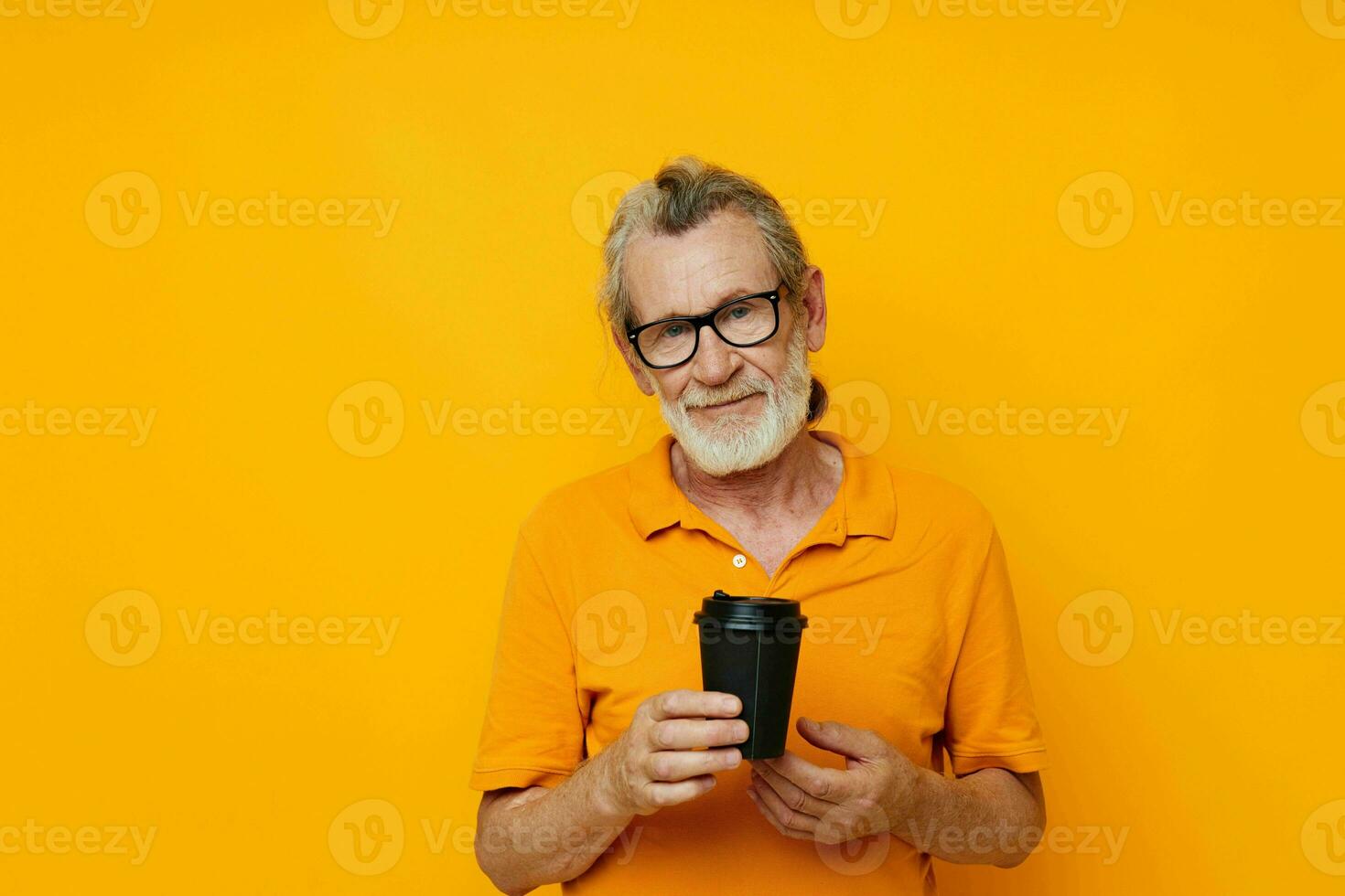 Portrait of happy senior man with black disposable cup isolated background photo