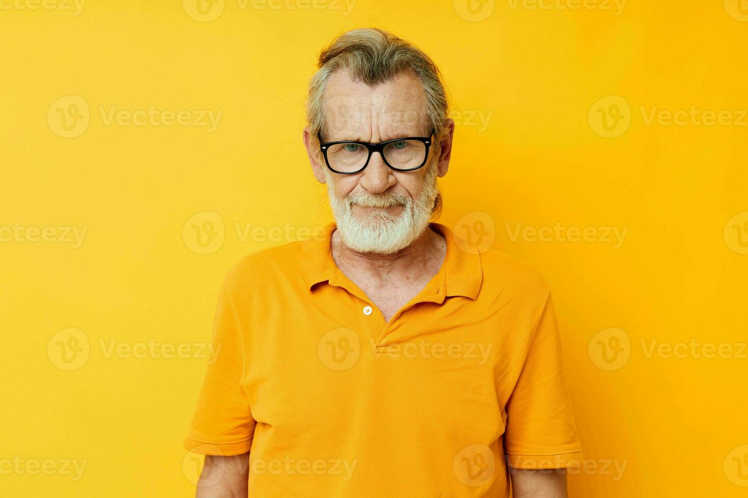 Portrait of happy senior man with a gray beard in glasses cropped view photo