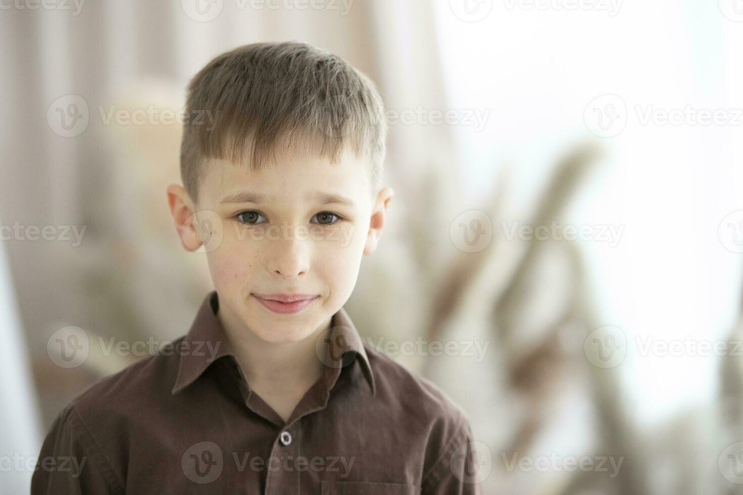 A boy of nine or ten years of European appearance is looking at the camera. photo