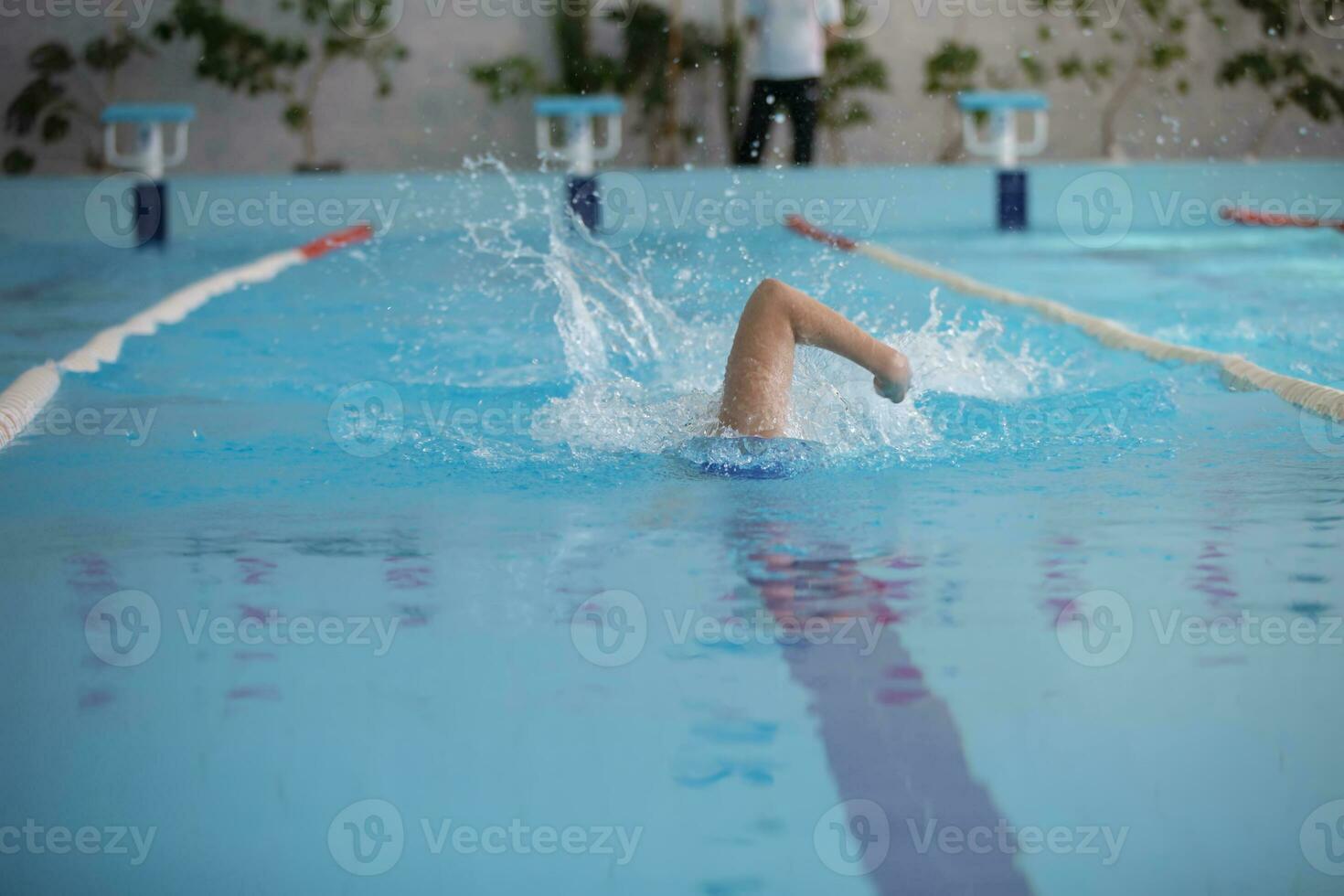 An athlete is swimming in the sports pool. photo