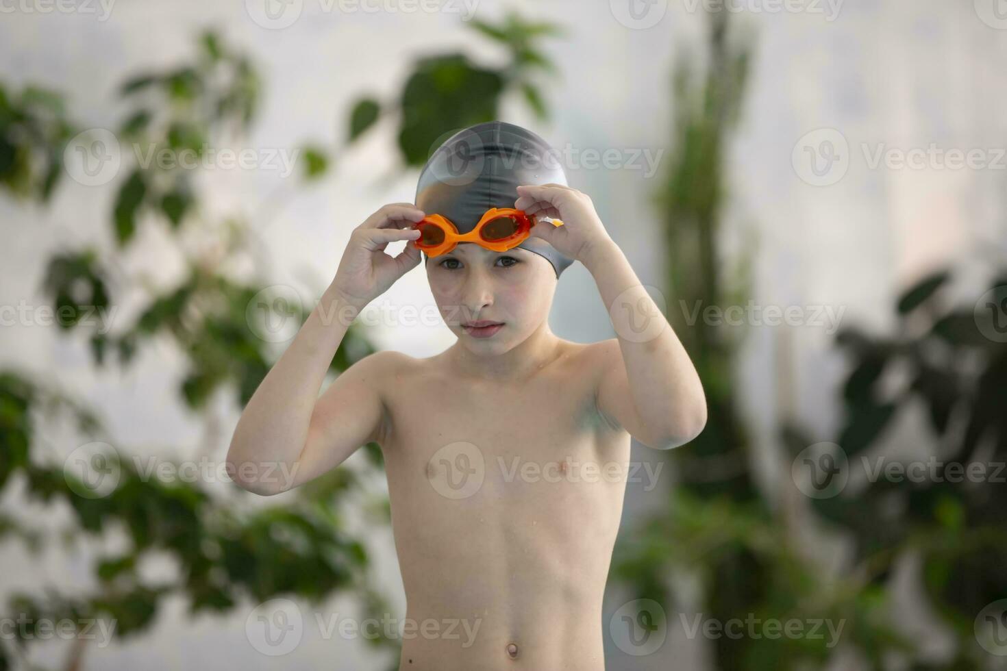 Boy in a swimming cap in the sports pool. photo