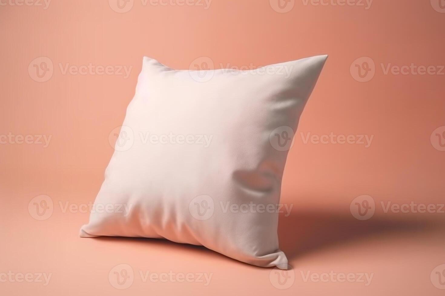 White pillow on a pink background. The pillow lies on a pink background photo