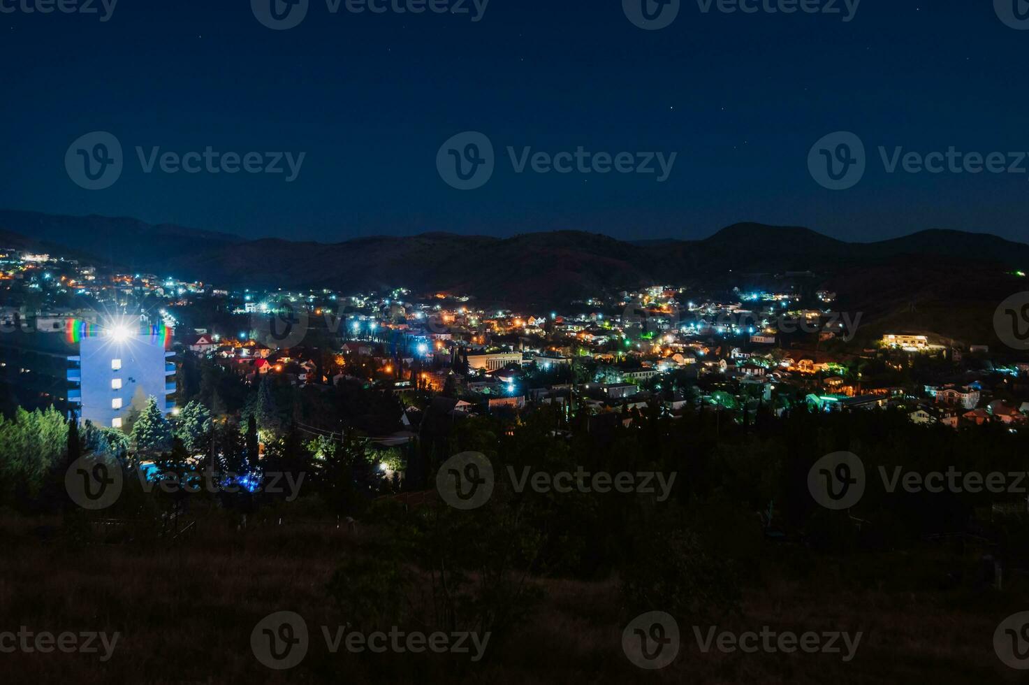 Night landscape. View of the night city in a hilly area. A small town in the Crimea photo