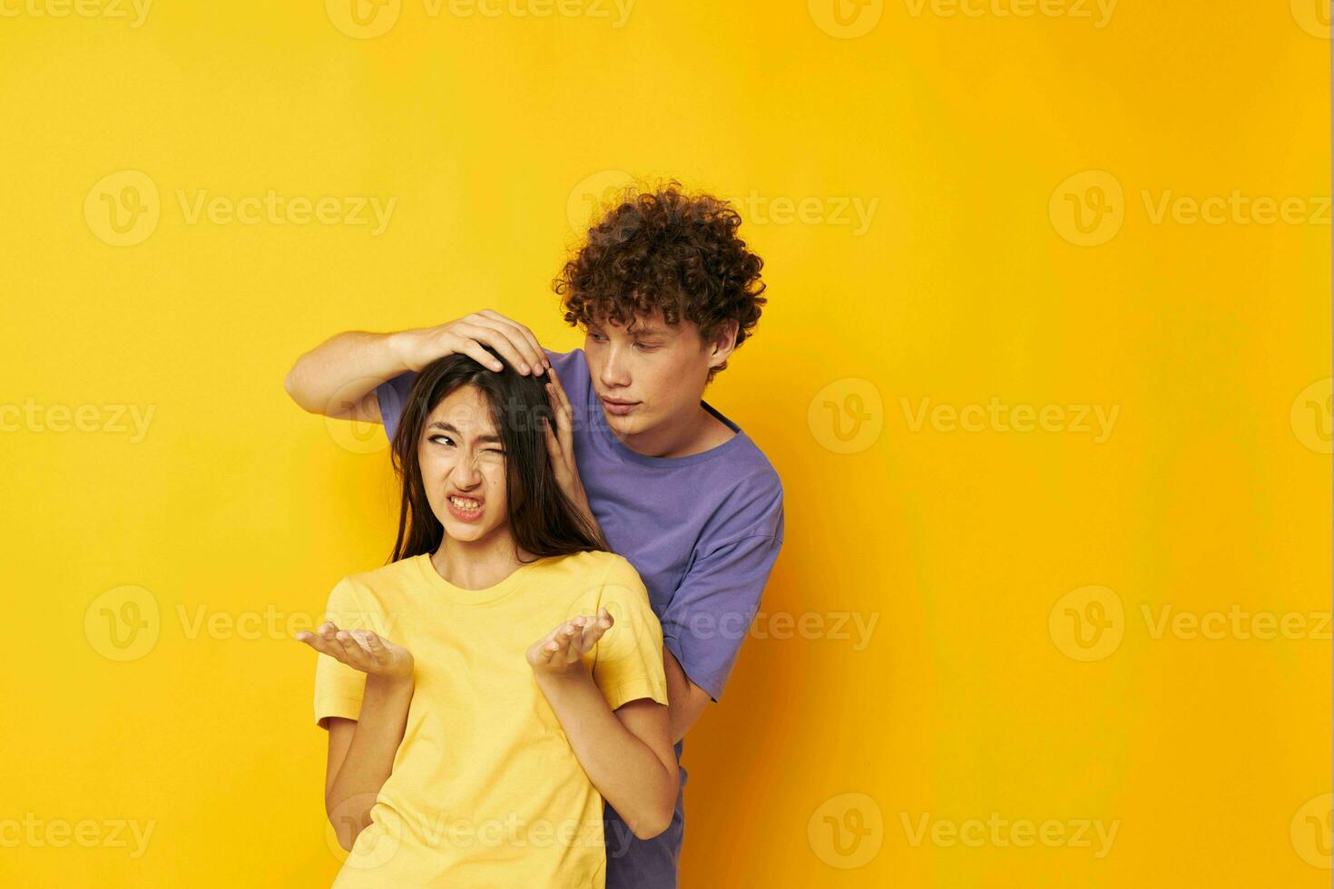 teenagers casual clothes posing emotions antics yellow background unaltered photo