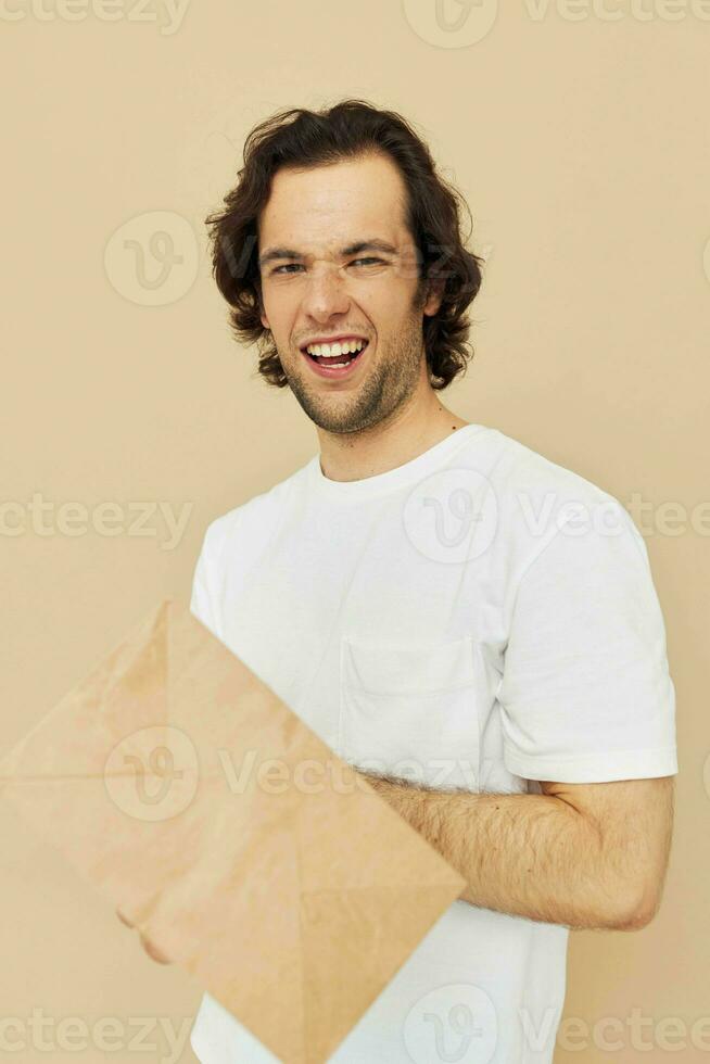 Cheerful man paper grocery bag posing isolated background photo