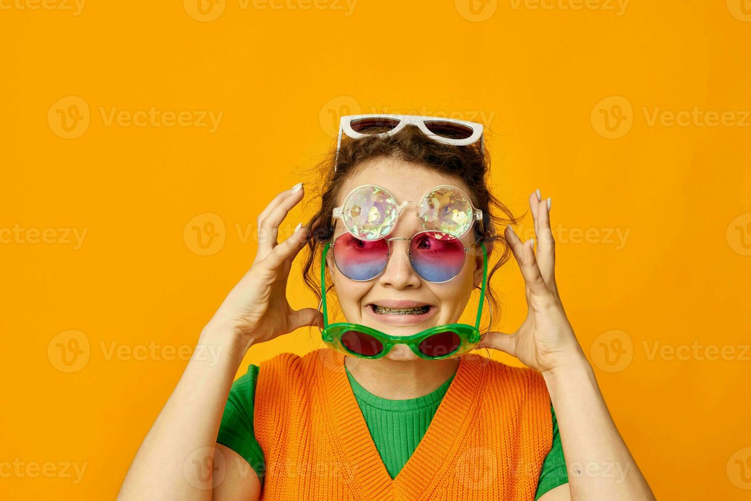 cheerful woman orange sweatshirts sunglasses multicolored glasses supply yellow background unaltered photo