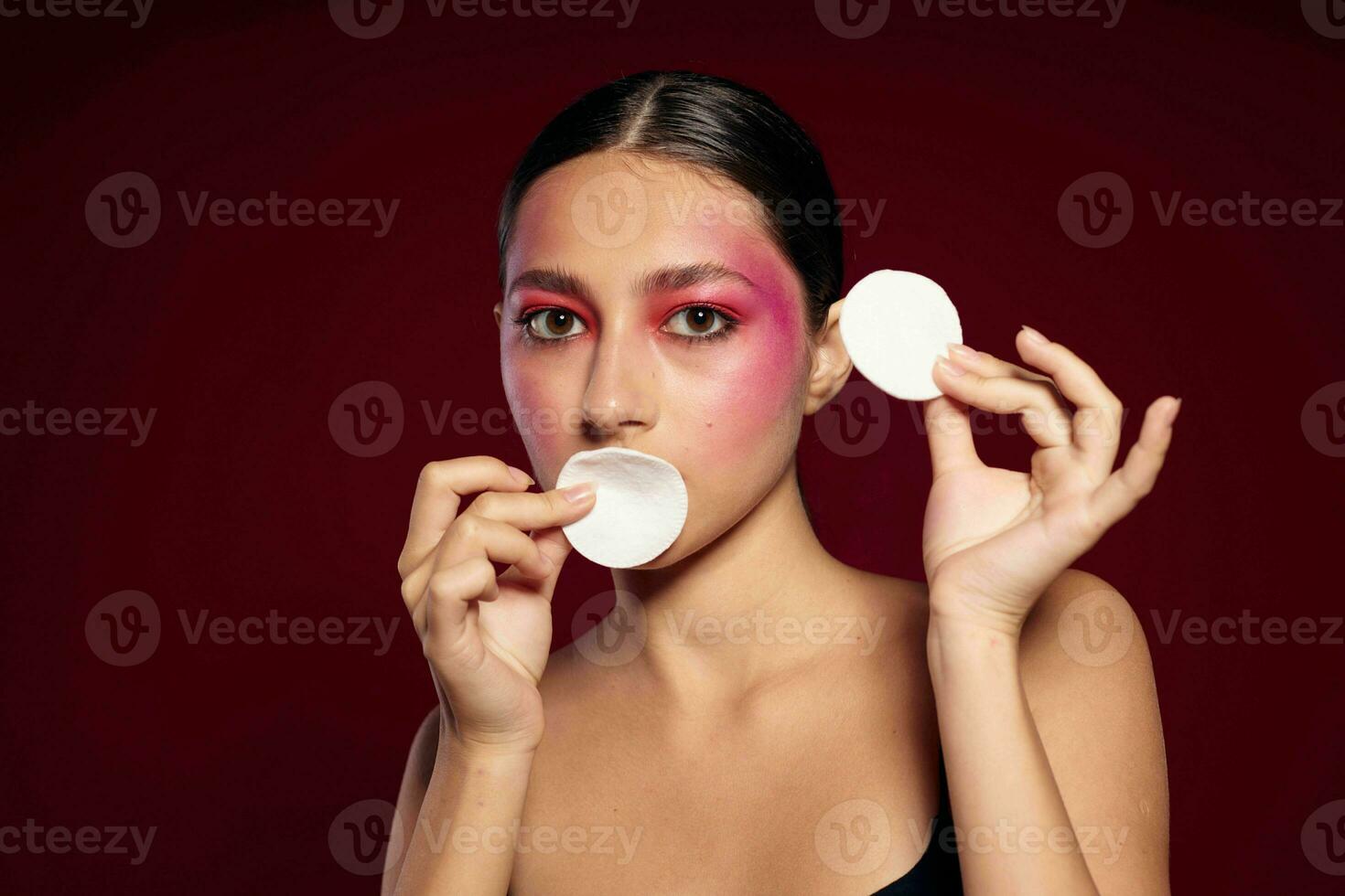 Portrait of beautiful young woman cotton pads clean leather bright makeup posing cropped view unaltered photo