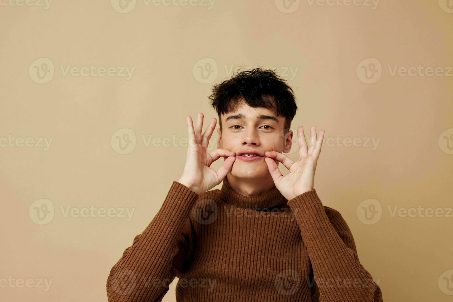A young man fashionable clothes posing studio modern style light background unaltered photo