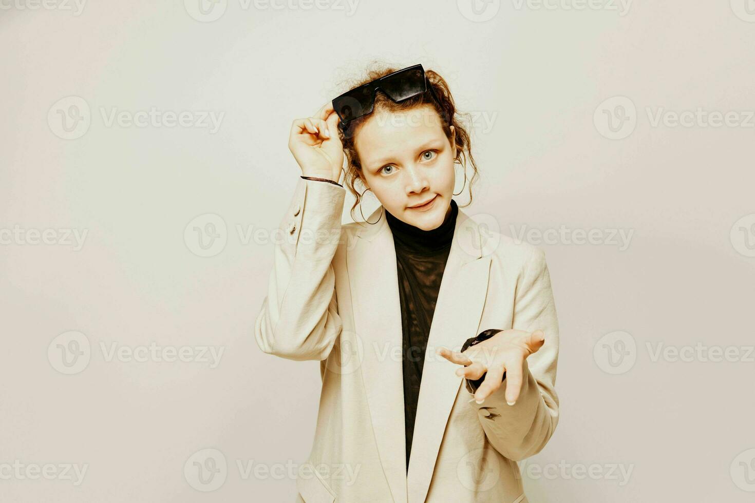 cheerful woman in a suit sunglasses gestures with his hands emotions isolated backgrounds unaltered photo