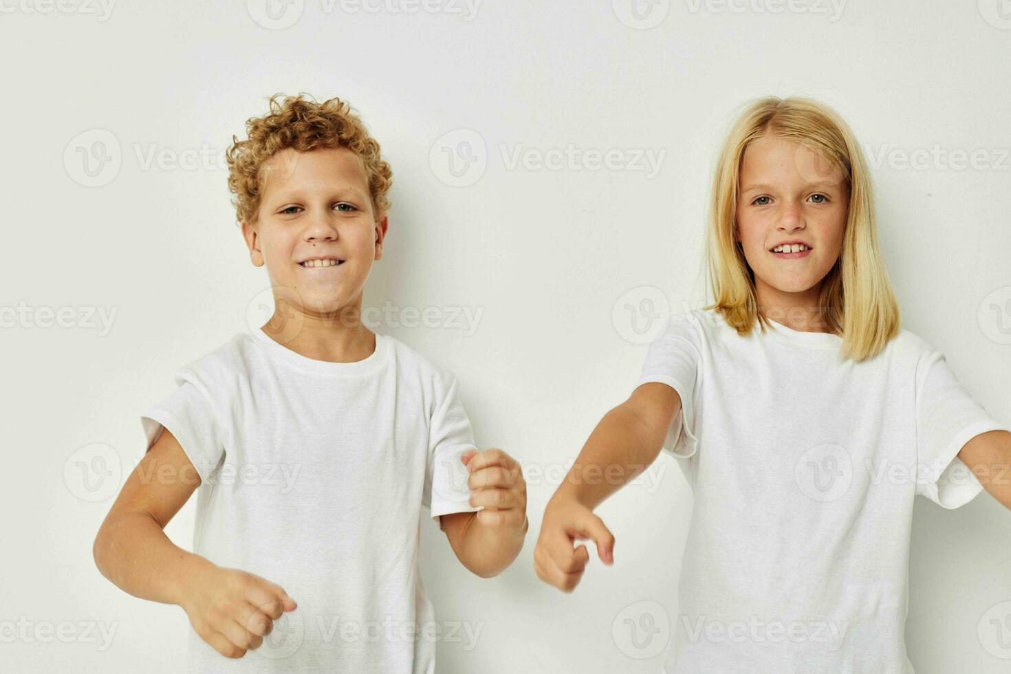 Portrait of cute children in white T-shirts are standing next to childhood unaltered photo