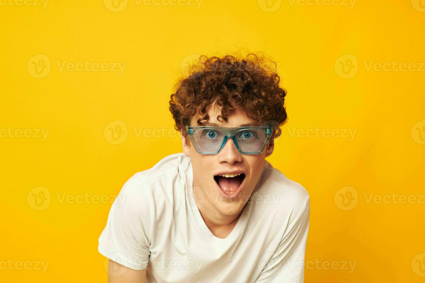 guy with red curly hair in blue glasses white t-shirt fashion modern style isolated background unaltered photo