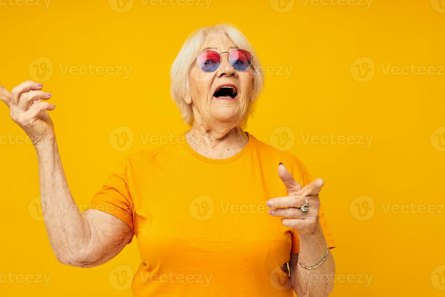 Photo of retired old lady happy lifestyle in yellow t-shirts cropped view