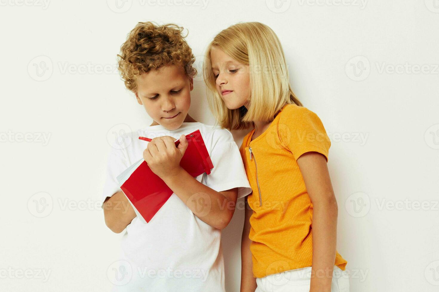 Cute preschool kids fun in colorful t-shirts with a notepad color background unaltered photo