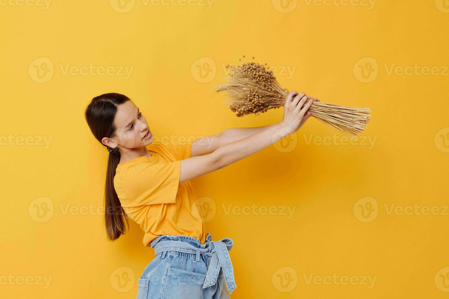 photo pretty girl fashion in yellow t-shirt dried flowers bouquet posing isolated background