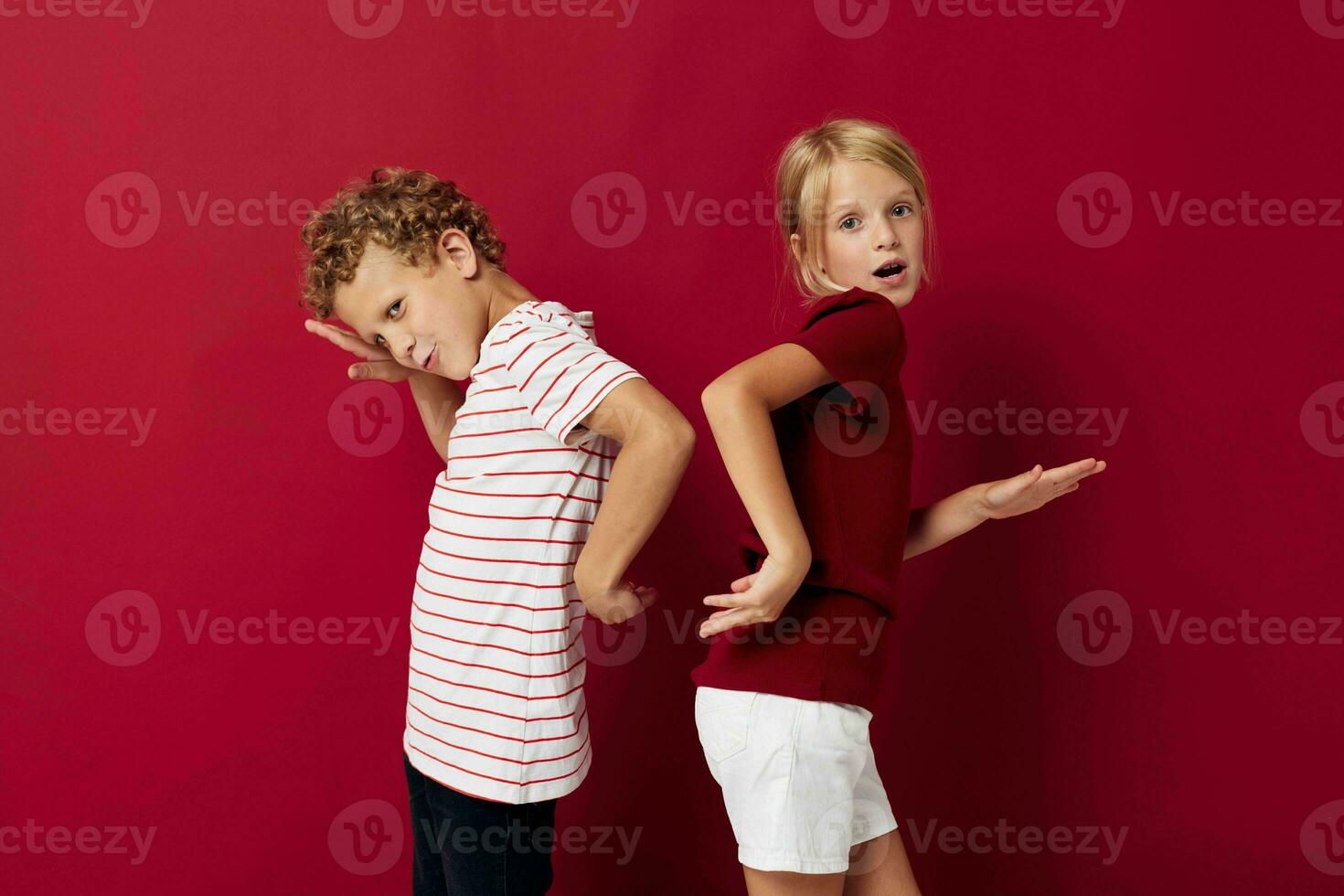 Cute preschool kids emotions stand side by side in everyday clothes red background photo