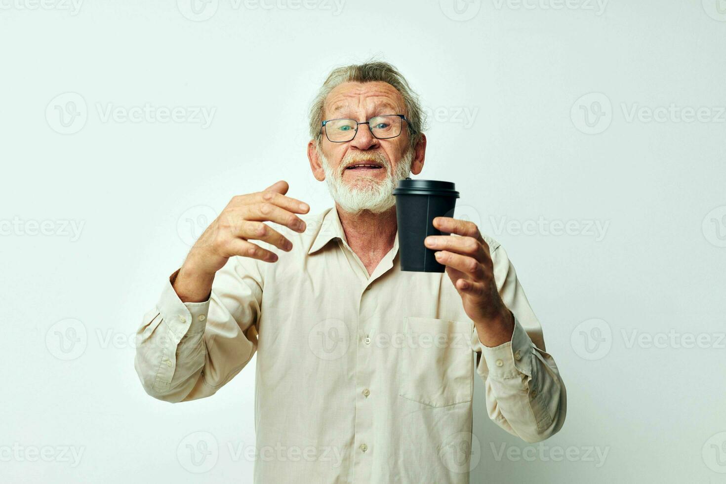 Senior grey-haired man in a shirt and glasses a black glass isolated background photo