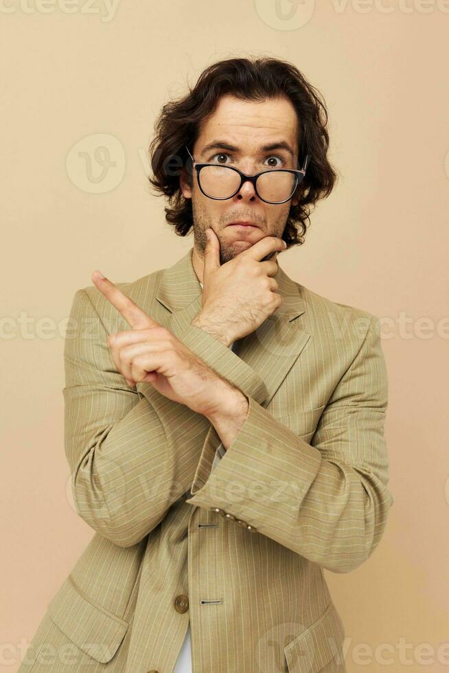 handsome man with glasses emotions gesture hands posing beige background photo